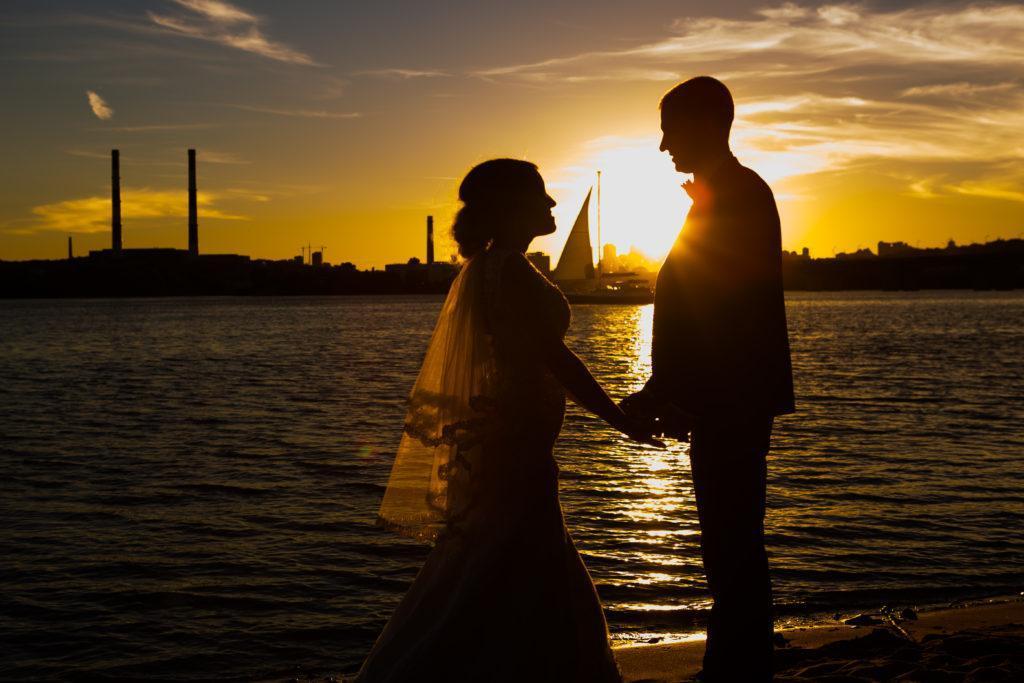 Beautiful wedding couple at sunset silhouettes