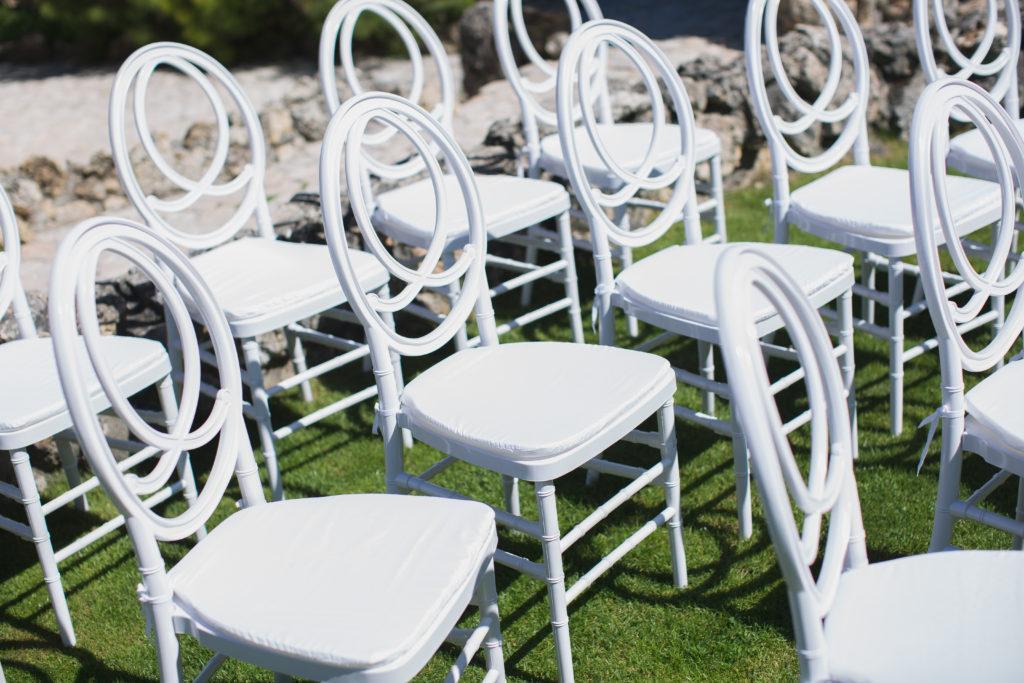 White chairs for guests at the wedding ceremony